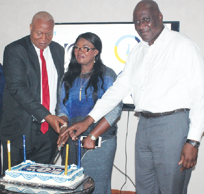 Mr Kenneth Thompson (rigth), together with  Professor Joshua Alabi (left) and Mrs Goski Alabi. (middle) cutting a cake to launch "THE JOB" competition.